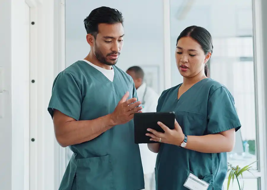 medical professionals looking at a tablet